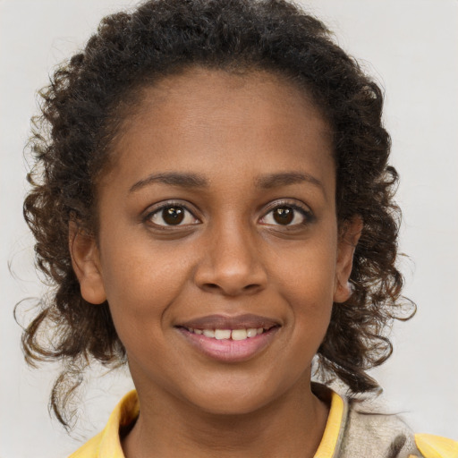 Joyful black young-adult female with medium  brown hair and brown eyes