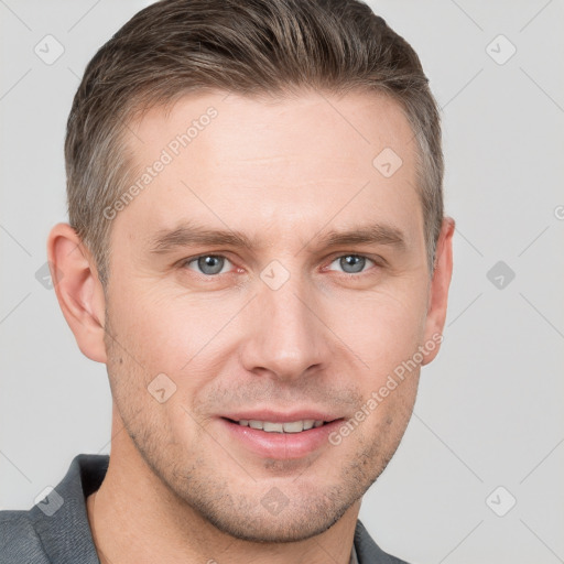 Joyful white young-adult male with short  brown hair and grey eyes