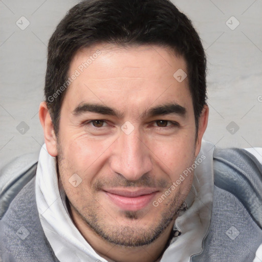 Joyful white adult male with short  brown hair and brown eyes