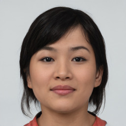 Joyful asian young-adult female with medium  black hair and brown eyes