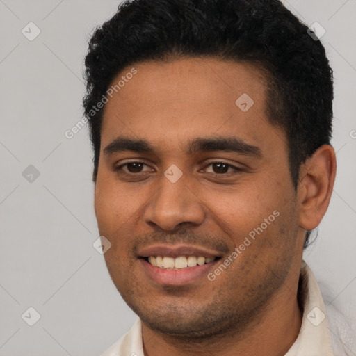 Joyful latino young-adult male with short  black hair and brown eyes