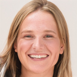 Joyful white adult female with long  brown hair and blue eyes