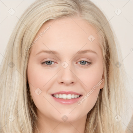 Joyful white young-adult female with long  brown hair and blue eyes