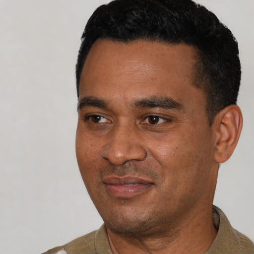 Joyful black young-adult male with short  black hair and brown eyes