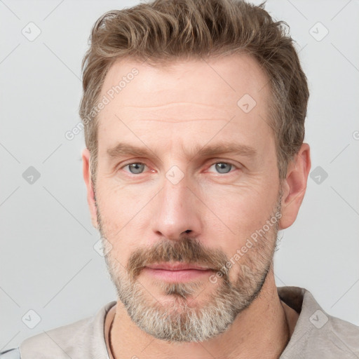 Neutral white adult male with short  brown hair and grey eyes