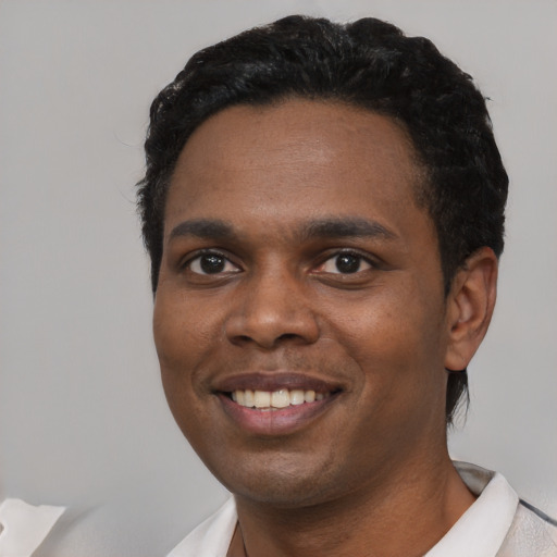 Joyful black young-adult male with short  black hair and brown eyes
