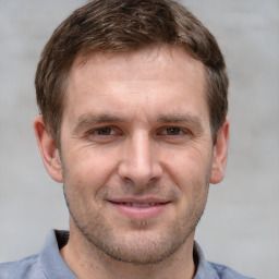 Joyful white adult male with short  brown hair and grey eyes