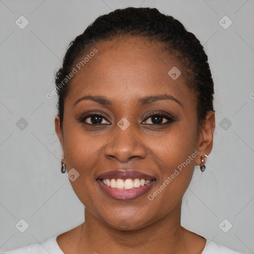 Joyful black young-adult female with short  brown hair and brown eyes