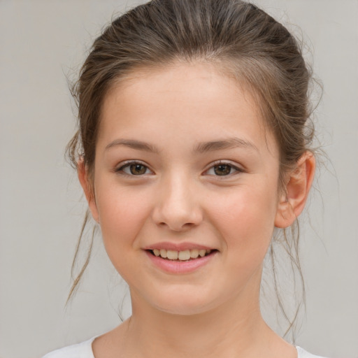 Joyful white child female with medium  brown hair and brown eyes