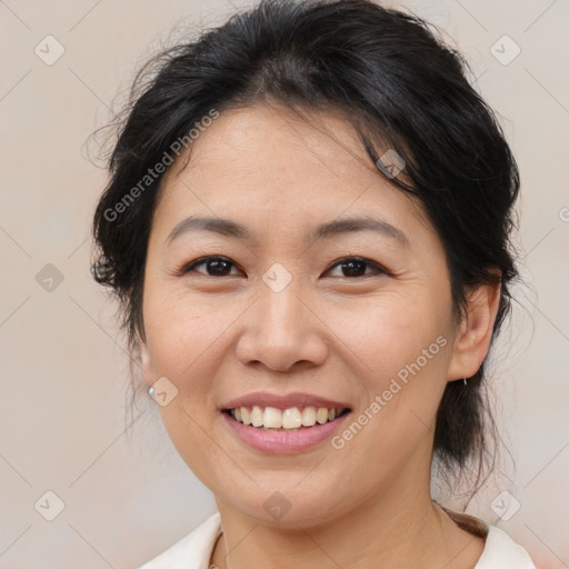 Joyful asian adult female with medium  brown hair and brown eyes