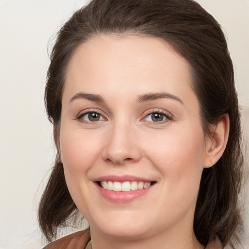 Joyful white young-adult female with medium  brown hair and brown eyes