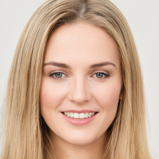 Joyful white young-adult female with long  brown hair and green eyes