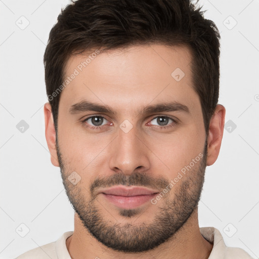 Joyful white young-adult male with short  brown hair and brown eyes