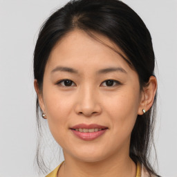 Joyful asian young-adult female with medium  brown hair and brown eyes