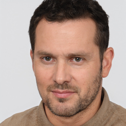 Joyful white adult male with short  brown hair and brown eyes