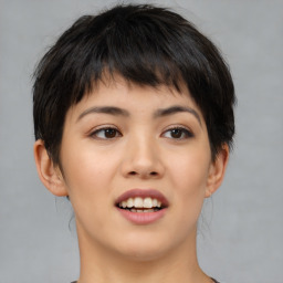 Joyful asian young-adult female with short  brown hair and brown eyes