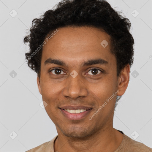 Joyful black young-adult male with short  brown hair and brown eyes