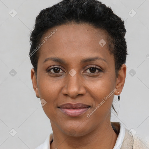 Joyful black young-adult female with short  brown hair and brown eyes