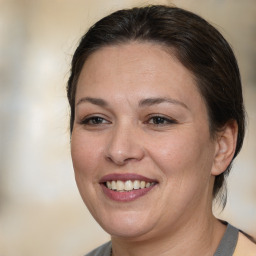 Joyful white adult female with medium  brown hair and brown eyes