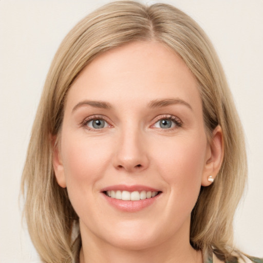 Joyful white young-adult female with medium  brown hair and blue eyes