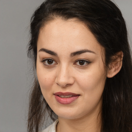 Joyful white young-adult female with long  brown hair and brown eyes