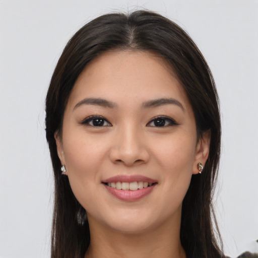 Joyful latino young-adult female with long  brown hair and brown eyes