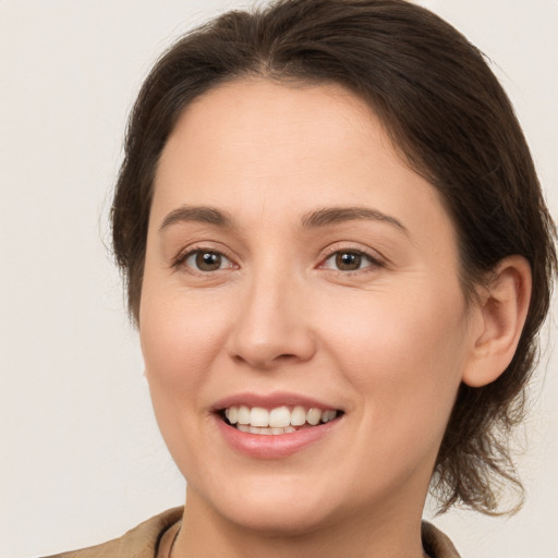 Joyful white young-adult female with medium  brown hair and brown eyes