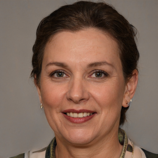 Joyful white adult female with medium  brown hair and grey eyes