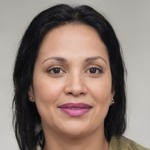 Joyful latino adult female with medium  brown hair and brown eyes