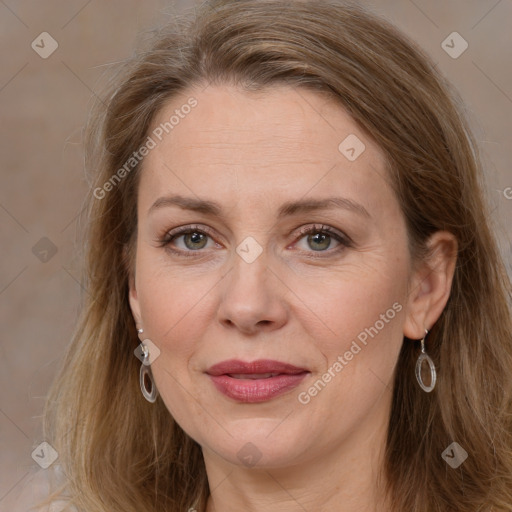 Joyful white adult female with long  brown hair and grey eyes