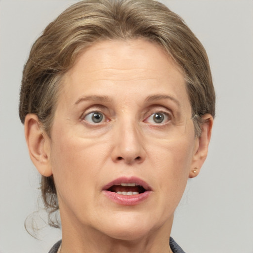 Joyful white adult female with medium  brown hair and grey eyes