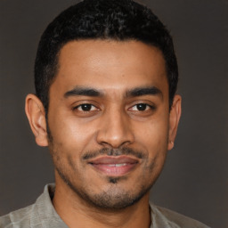 Joyful latino young-adult male with short  black hair and brown eyes