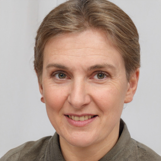 Joyful white adult female with short  brown hair and grey eyes