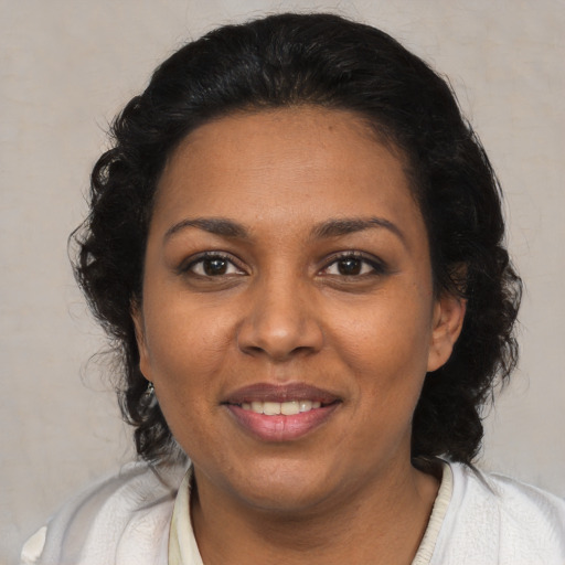 Joyful black young-adult female with medium  brown hair and brown eyes