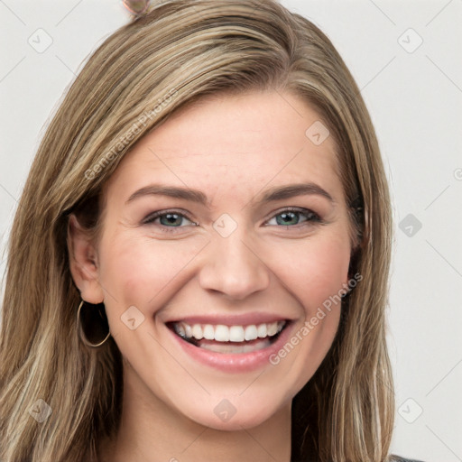 Joyful white young-adult female with long  brown hair and green eyes