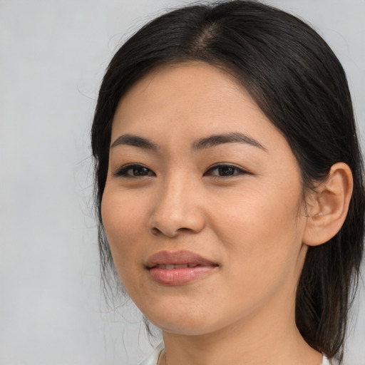 Joyful asian young-adult female with medium  brown hair and brown eyes