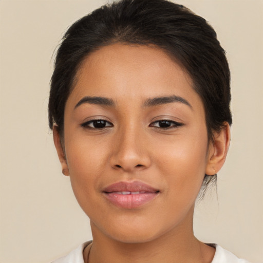 Joyful latino young-adult female with medium  brown hair and brown eyes