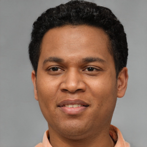 Joyful black young-adult male with short  black hair and brown eyes