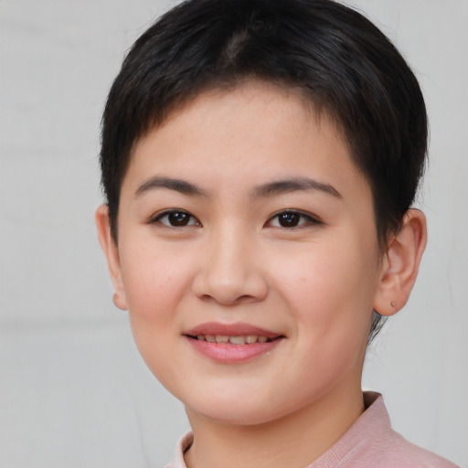 Joyful asian young-adult female with short  brown hair and brown eyes