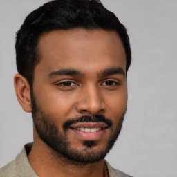 Joyful black young-adult male with short  black hair and brown eyes