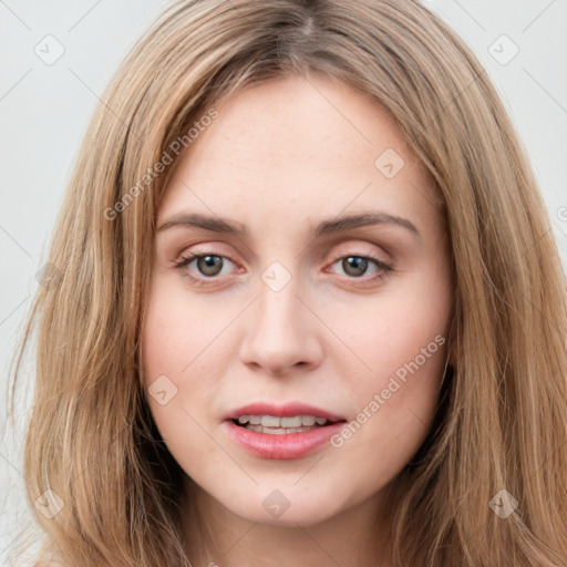 Joyful white young-adult female with long  brown hair and green eyes