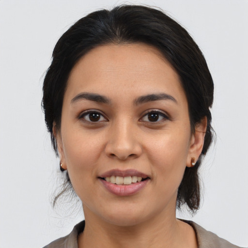 Joyful latino young-adult female with medium  black hair and brown eyes