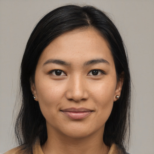 Joyful latino young-adult female with medium  brown hair and brown eyes