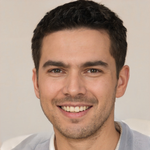 Joyful white young-adult male with short  brown hair and brown eyes