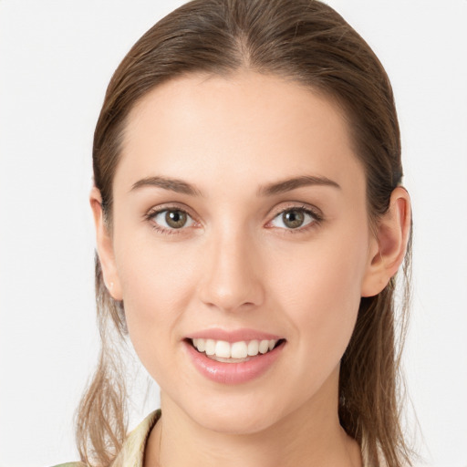 Joyful white young-adult female with medium  brown hair and blue eyes