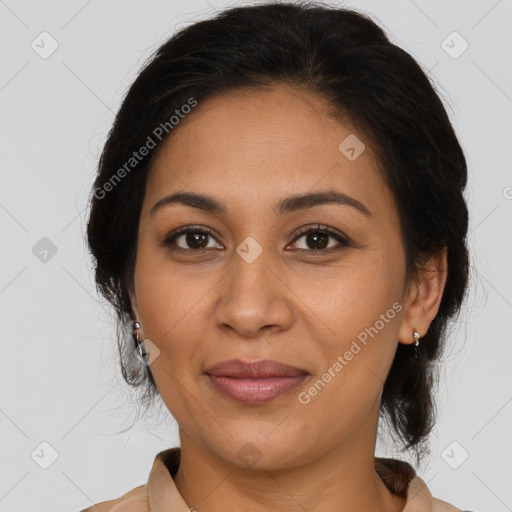 Joyful latino adult female with medium  brown hair and brown eyes