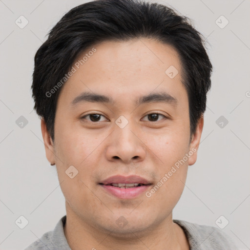 Joyful asian young-adult male with short  black hair and brown eyes