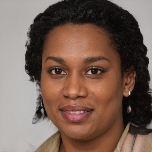 Joyful black young-adult female with medium  black hair and brown eyes