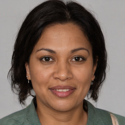 Joyful white adult female with medium  brown hair and brown eyes