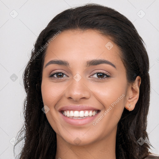 Joyful latino young-adult female with long  brown hair and brown eyes